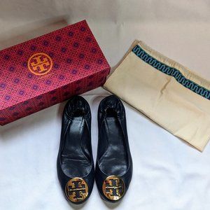 Tory Burch leather navy blue flat with gold logo hardware.